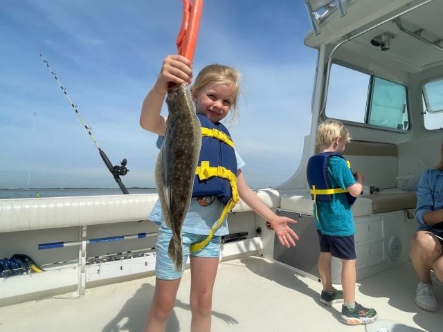 1.4 Mighty Heron Charters little girl catches flounder