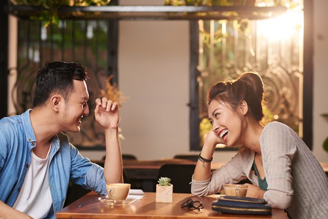 Laughing Couple on Date in Cafe